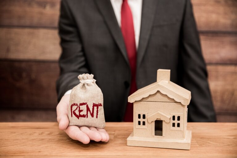 A housing concept of a landlord or home owner with a bag of money for rent and real estate agent